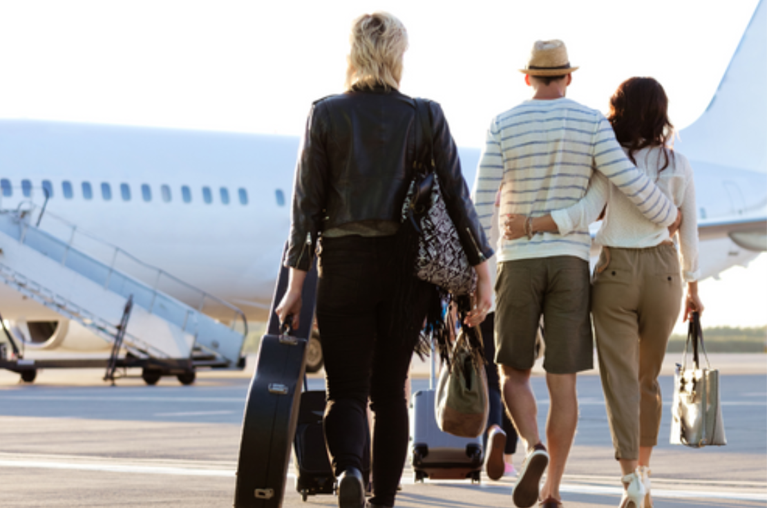 People walking on tarmac to airplane
